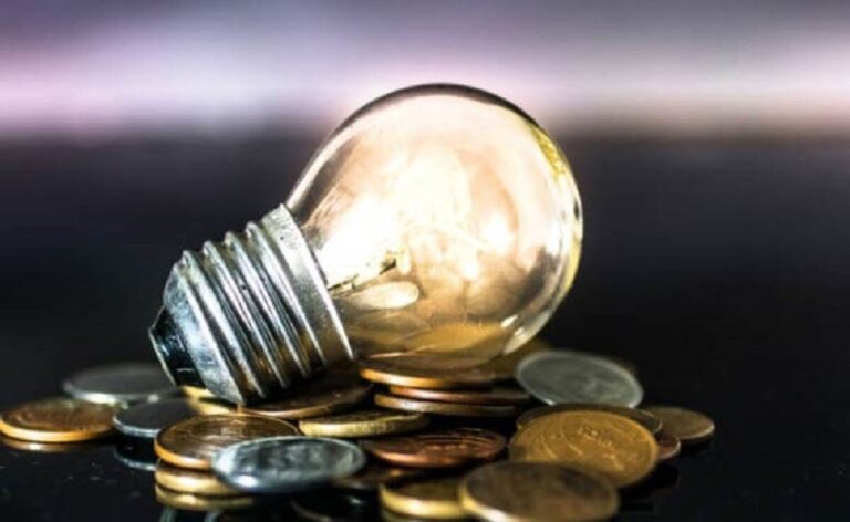light bulb on over pile of coins