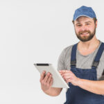 bearded-man-in-overall-using-tablet