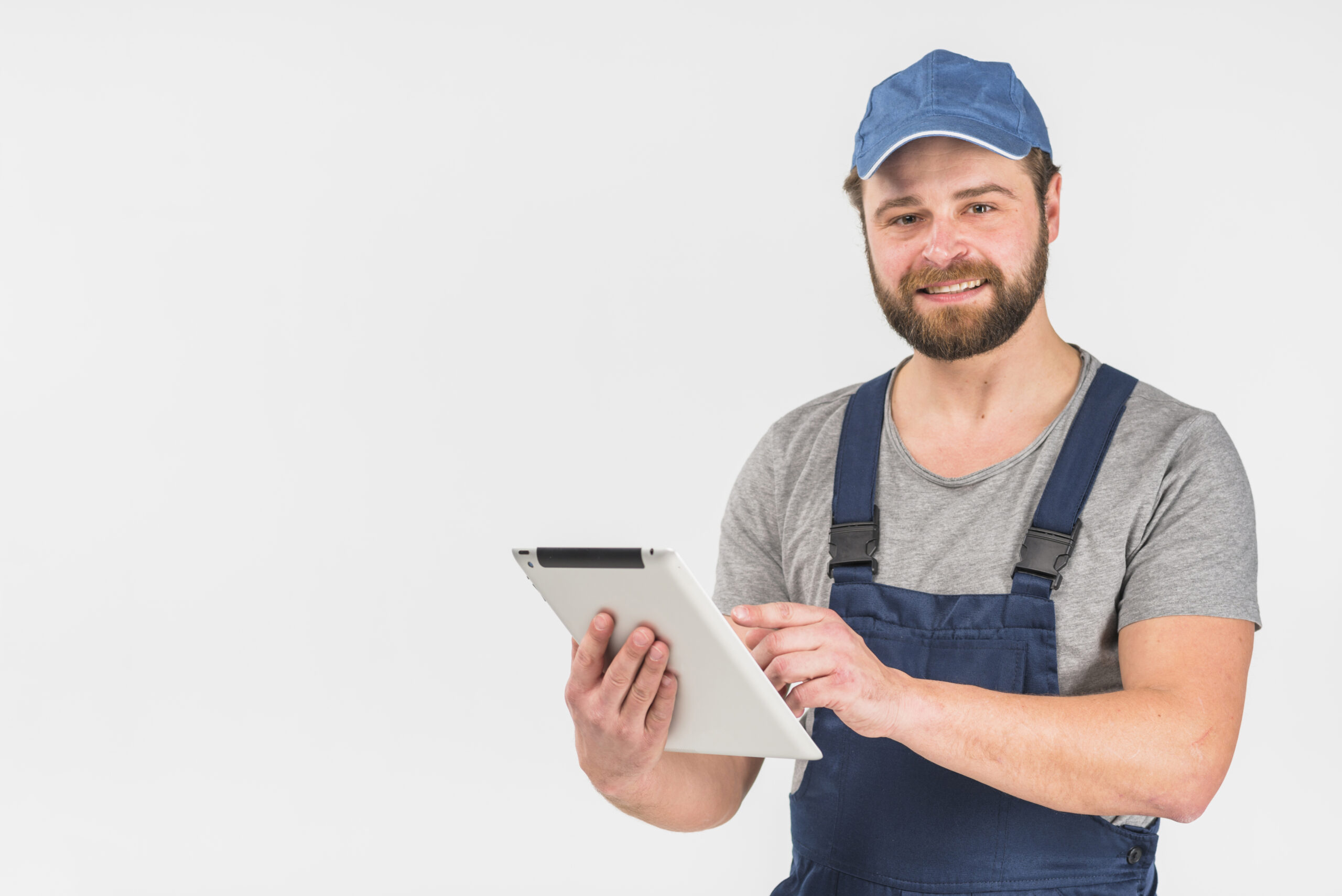 bearded-man-in-overall-using-tablet