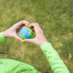 heart-shape-hands-surrounds-the-colorful-plasticine-planet