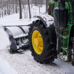 Cleaning machine is removing snow from road