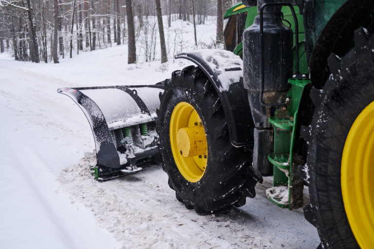 Cleaning machine is removing snow from road