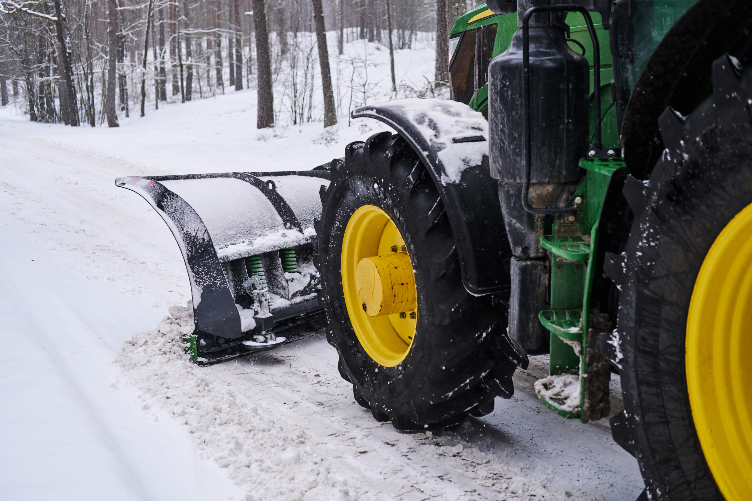 Cleaning machine is removing snow from road