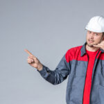 front-view-male-builder-in-uniform-and-helmet-on-gray-background