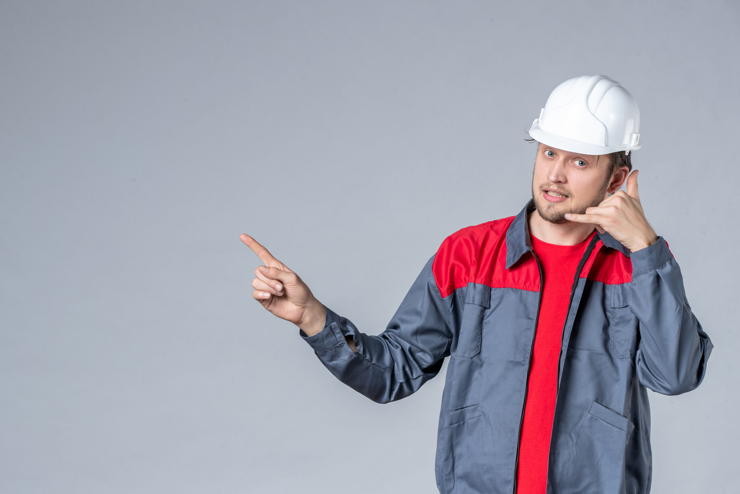 front-view-male-builder-in-uniform-and-helmet-on-gray-background