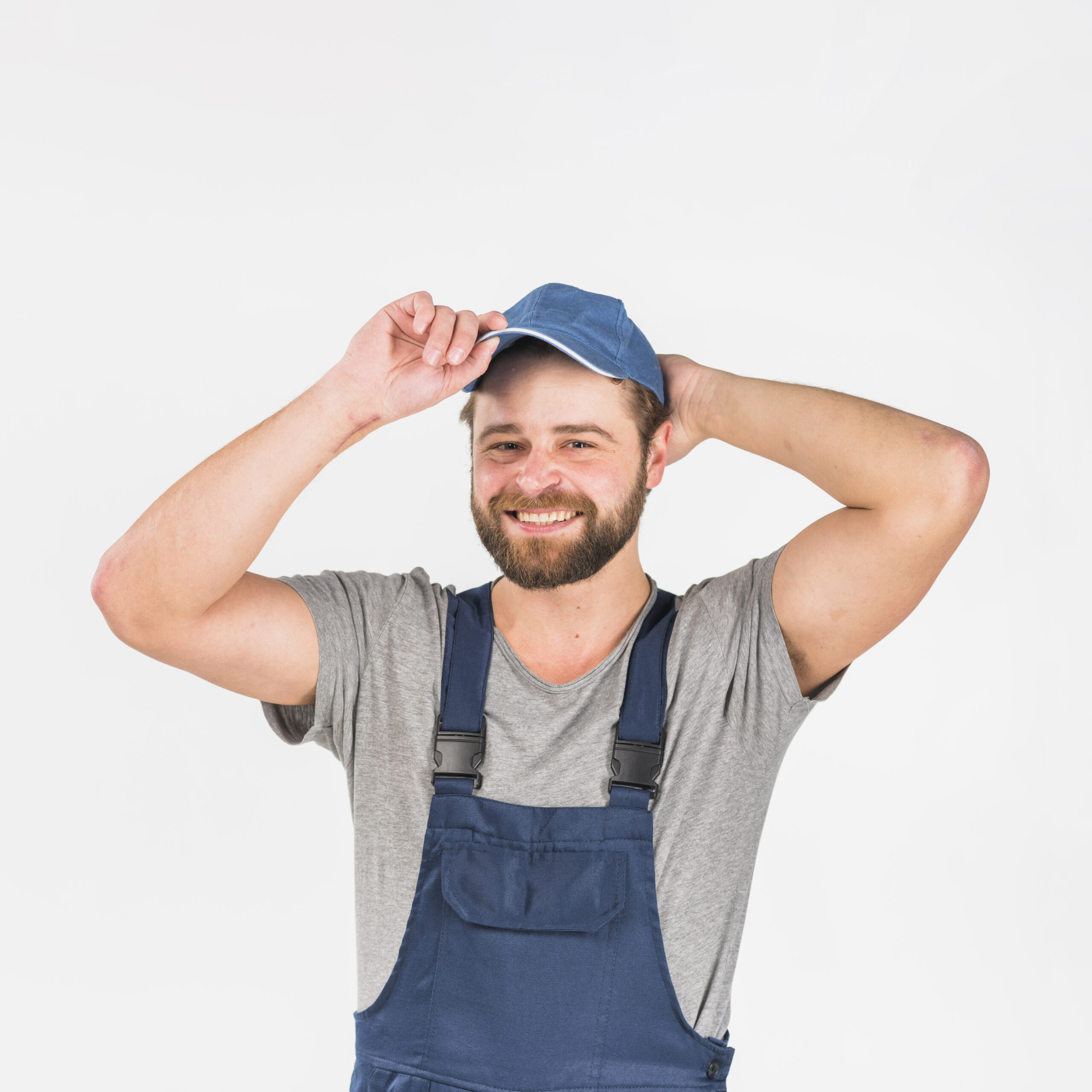 man-in-overall-putting-cap-on-head