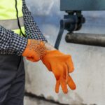 worker-putting-on-protective-gloves