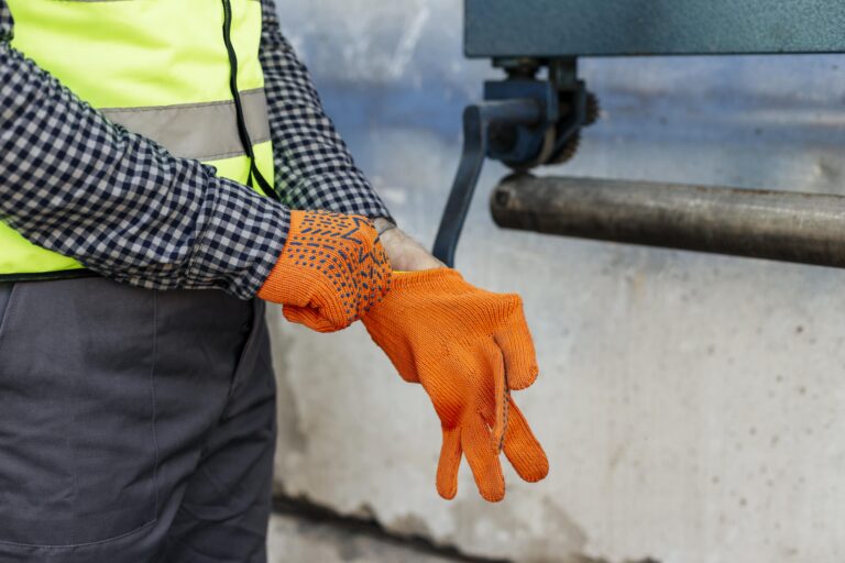 worker-putting-on-protective-gloves