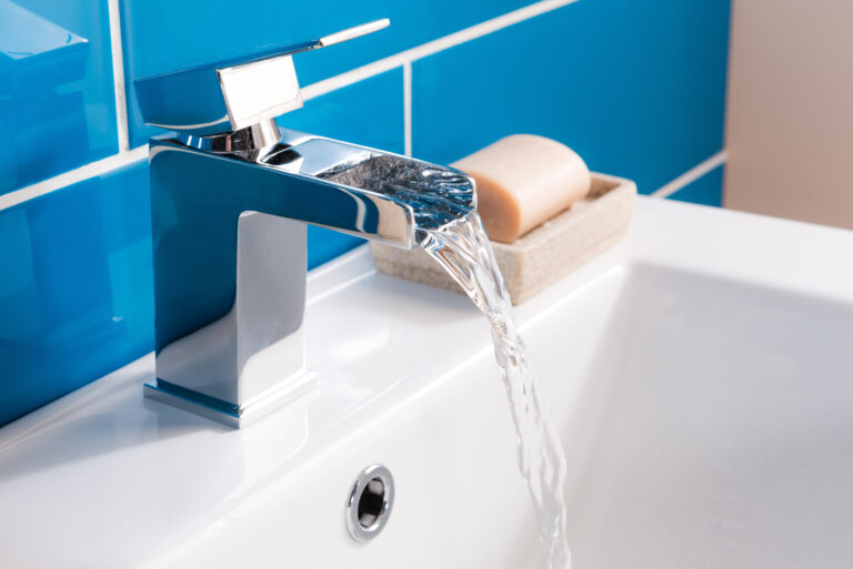 New and modern steel faucet with the ceramic sink in the bathroom