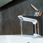 open-chrome-washbasin-with-low-water-pressure-in-the-bathroom_156139-631