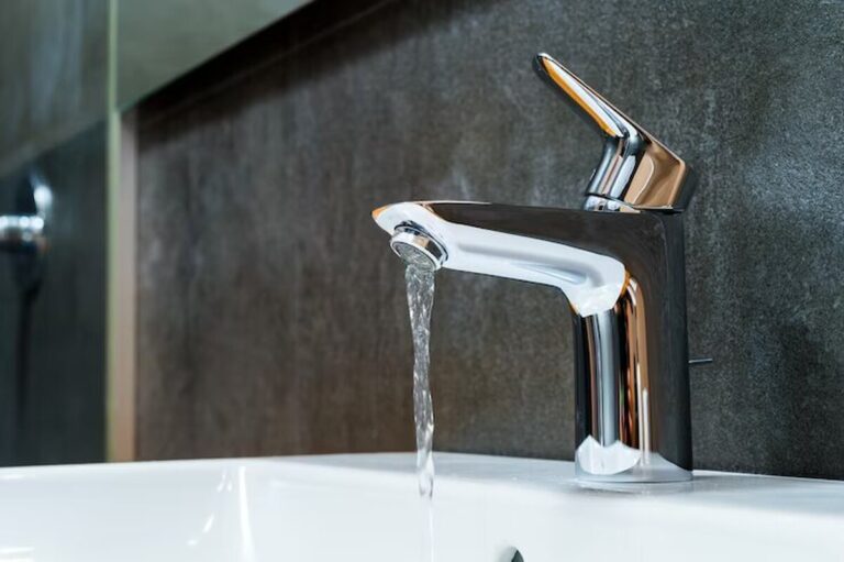 open-chrome-washbasin-with-low-water-pressure-in-the-bathroom_156139-631