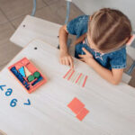 top-view-of-a-smart-concentrated-kid-solving-logical-complex-children-s-riddles-child-development-knowledges-concept-photo-with-noise_161422-113