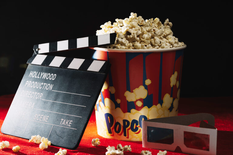 clapperboard-near-popcorn-bucket-and-3d-glasses