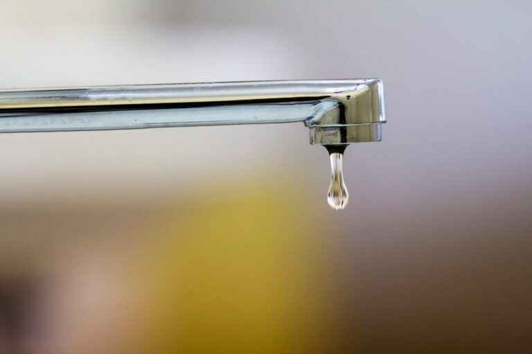 close-up-of-faucet-with-turned-drop-water-in-modern-bathroom-horizontal-crop-with-shallow-depth-of-field_127089-1829