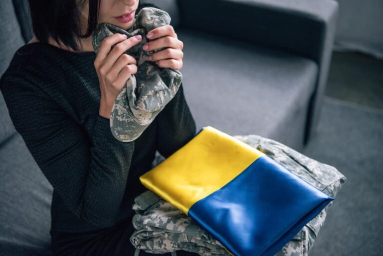 cropped-view-of-upset-woman-holding-military-cloth-2022-12-30-20-16-28-utc