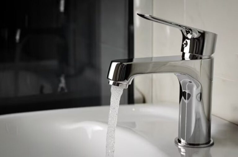 water-flows-from-the-tap-or-faucet-in-bathroom-copy-space-close-up_106885-1346