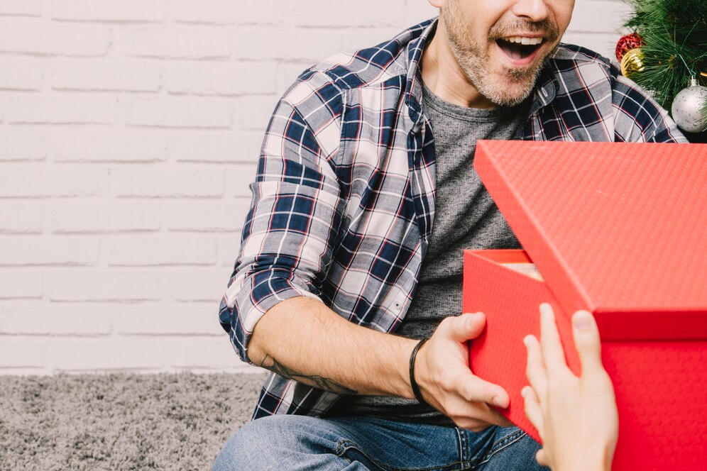 joyful-man-receiving-present_23-2147723773