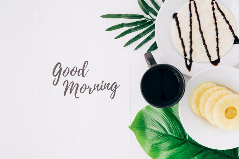 pineapple-slices-tortillas-and-coffee-on-leaves-with-good-morning-text-on-paper-over-white-background_23-21