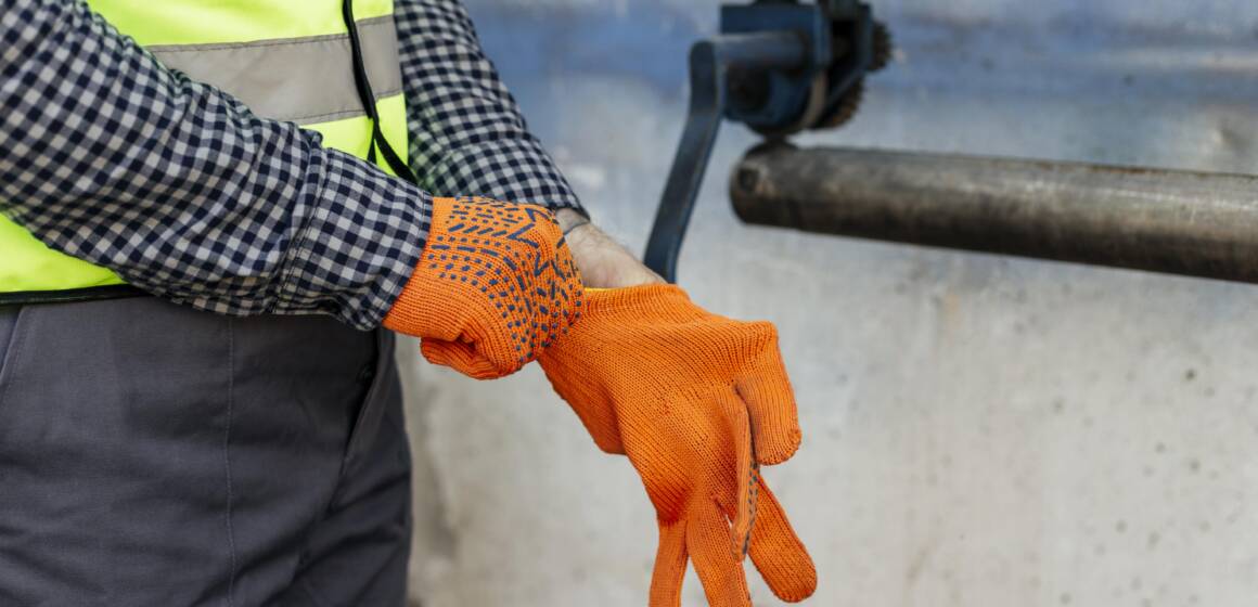 worker-putting-on-protective-gloves-1160x560-2